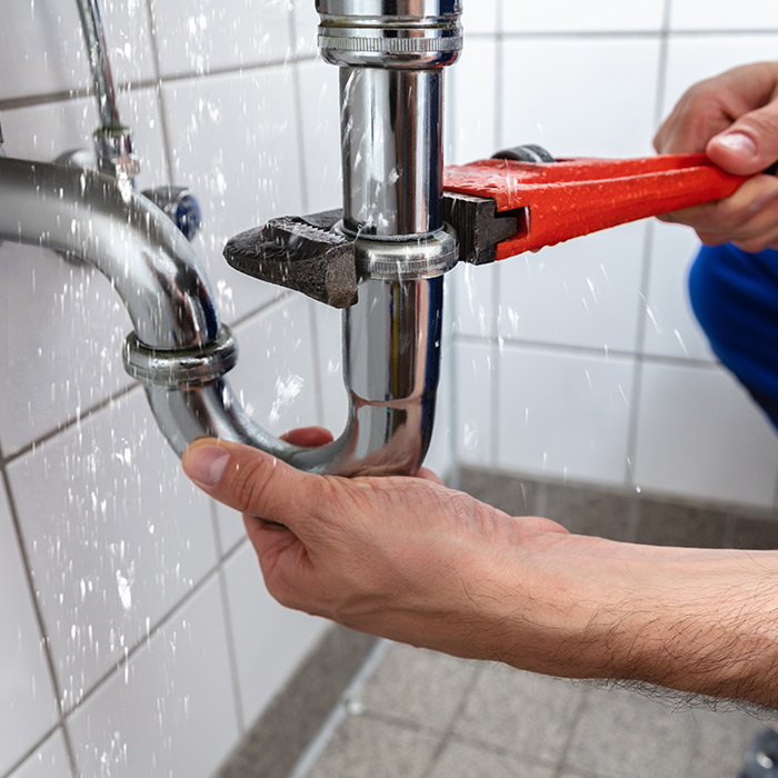 plumber-hands-close-up-with-tools-repairing-leaking-bathroom-pipe-st-charles-mo